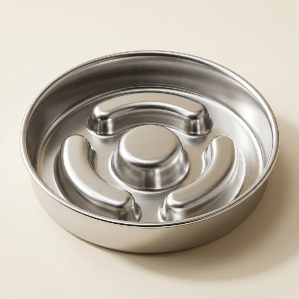 Empty stainless-steel slow feeder showing three curved baffles and a central post.