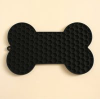 CloudSleep Lick Mat — black bone-shaped silicone mat with honeycomb texture and hanging loop.