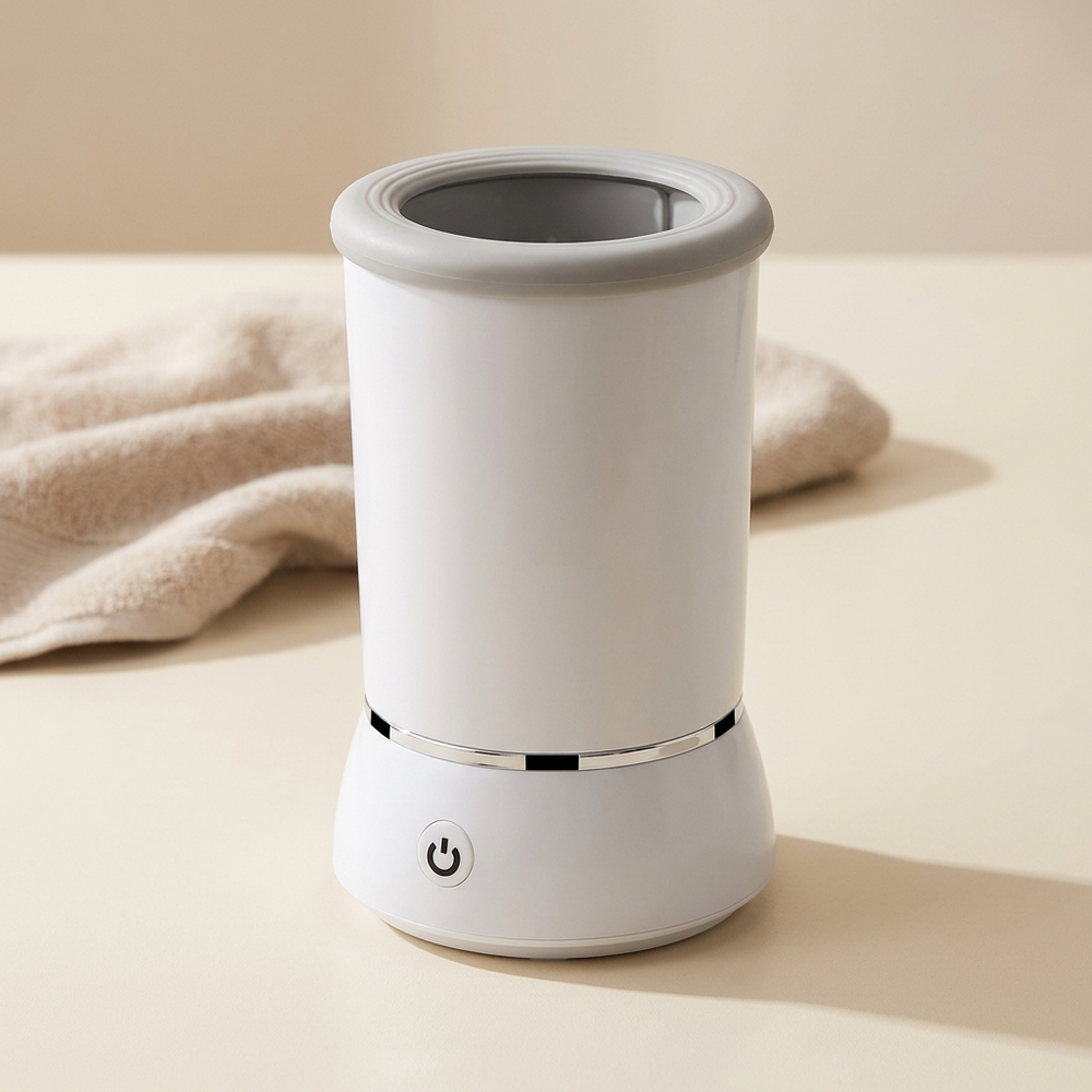 White paw cleaner cup on a countertop beside a neutral towel.