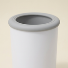 Close-up of the white paw cleaner’s grey rim and opening.