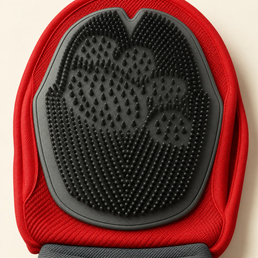 Close-up of the grooming mitten’s dark silicone palm and red fabric edge.