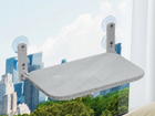 CloudSleep window hammock for cats with gray plush cover, mounted on a window with suction cups