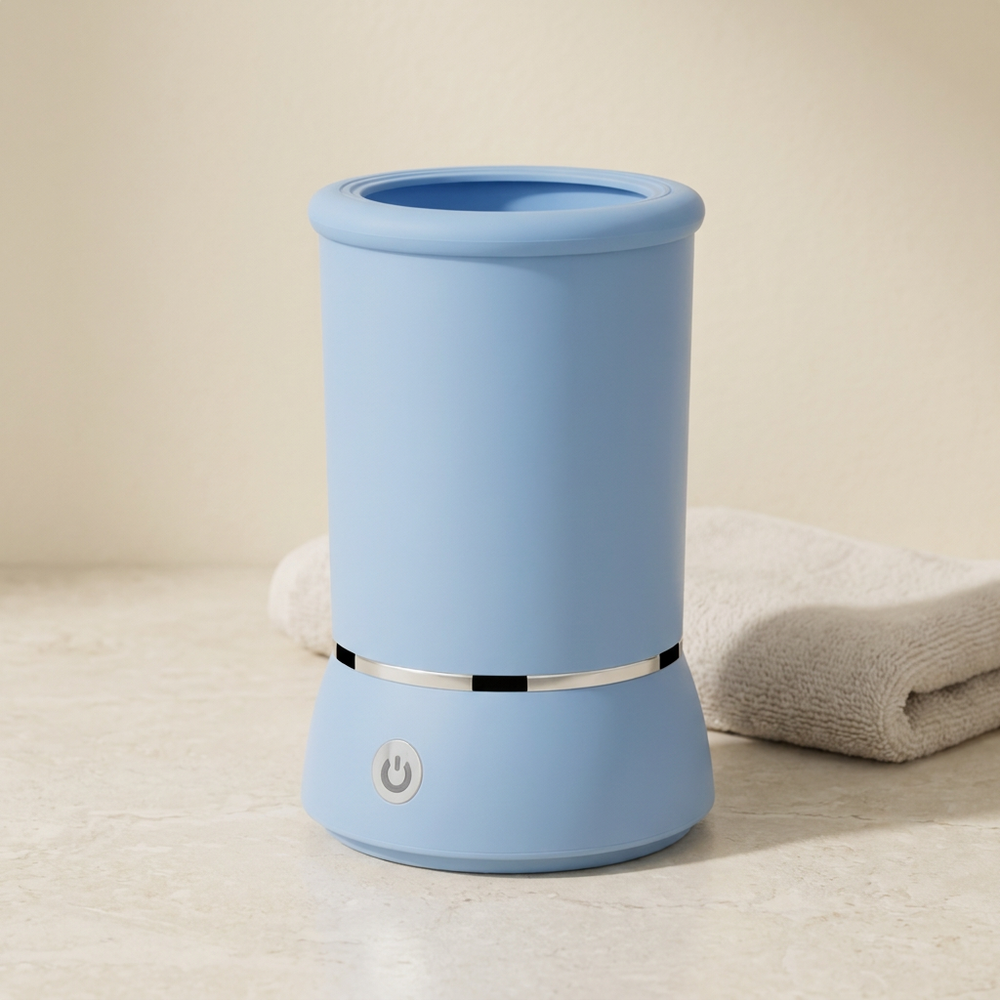 Blue paw cleaner cup on a pale stone counter with a neutral towel behind it.