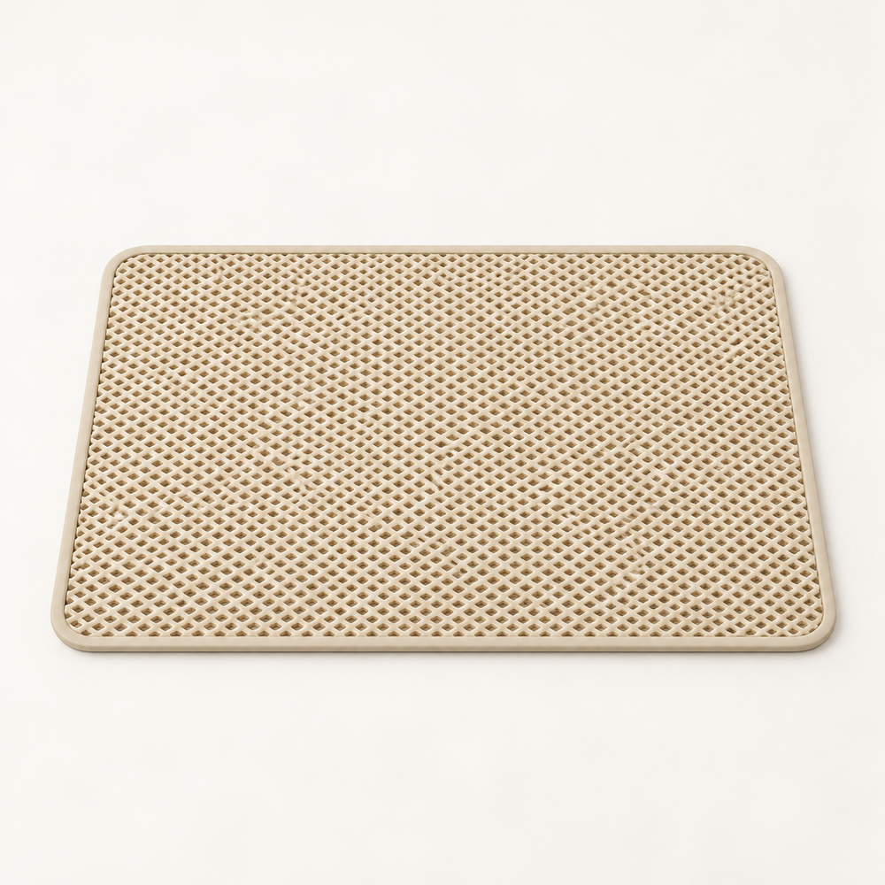 Beige lattice cat litter mat with rounded corners and pale border on a warm neutral studio background.