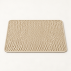 Beige lattice cat litter mat with rounded corners and pale border on a warm neutral studio background.