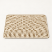 Beige lattice cat litter mat with rounded corners and pale border on a warm neutral studio background.