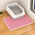 Pink lattice cat litter mat beneath a white litter tray in a bright room; the tray is a prop and is not included.